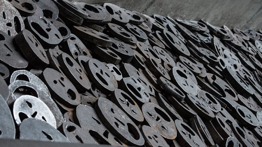 Taideteos, jossa metallisia huutavien kasvojen muotoja vierekkäin ja päällekkäin. Menashe Kadishmanin installaatio Berliinin juutalaisessa museossa.